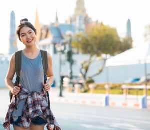 Traveler Asian woman traveling and walking in Bangkok, Thailand, Traveler Asian woman traveling and walking in Bangkok, Thailand, backpacker female feeling happy spending relax time in holiday trip. Lifestyle women travel in Asia city concept.